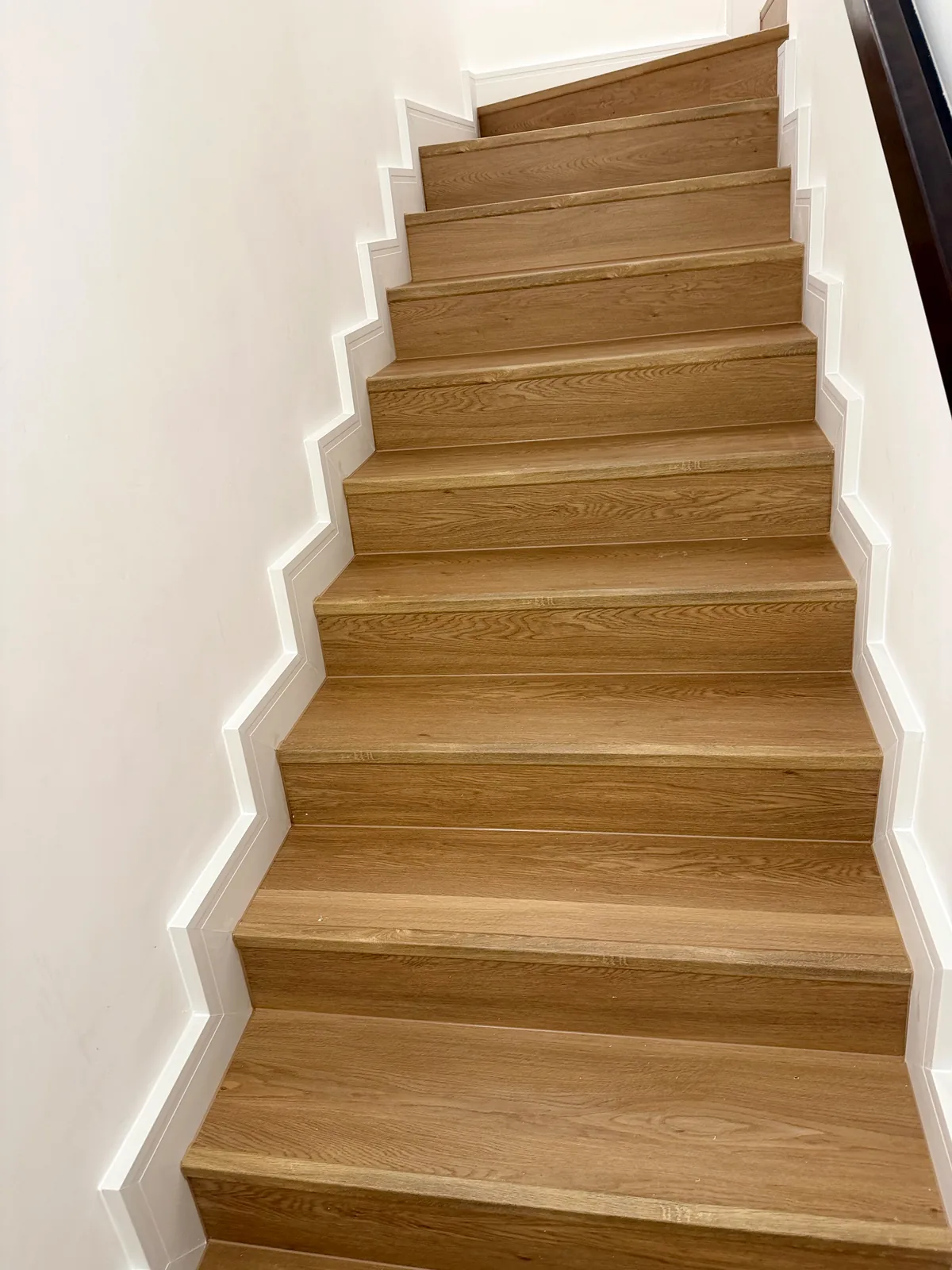 Looking up a stair flight clad in SPC flooring, Aura Gardens Tilal Al Ghaf Dubai