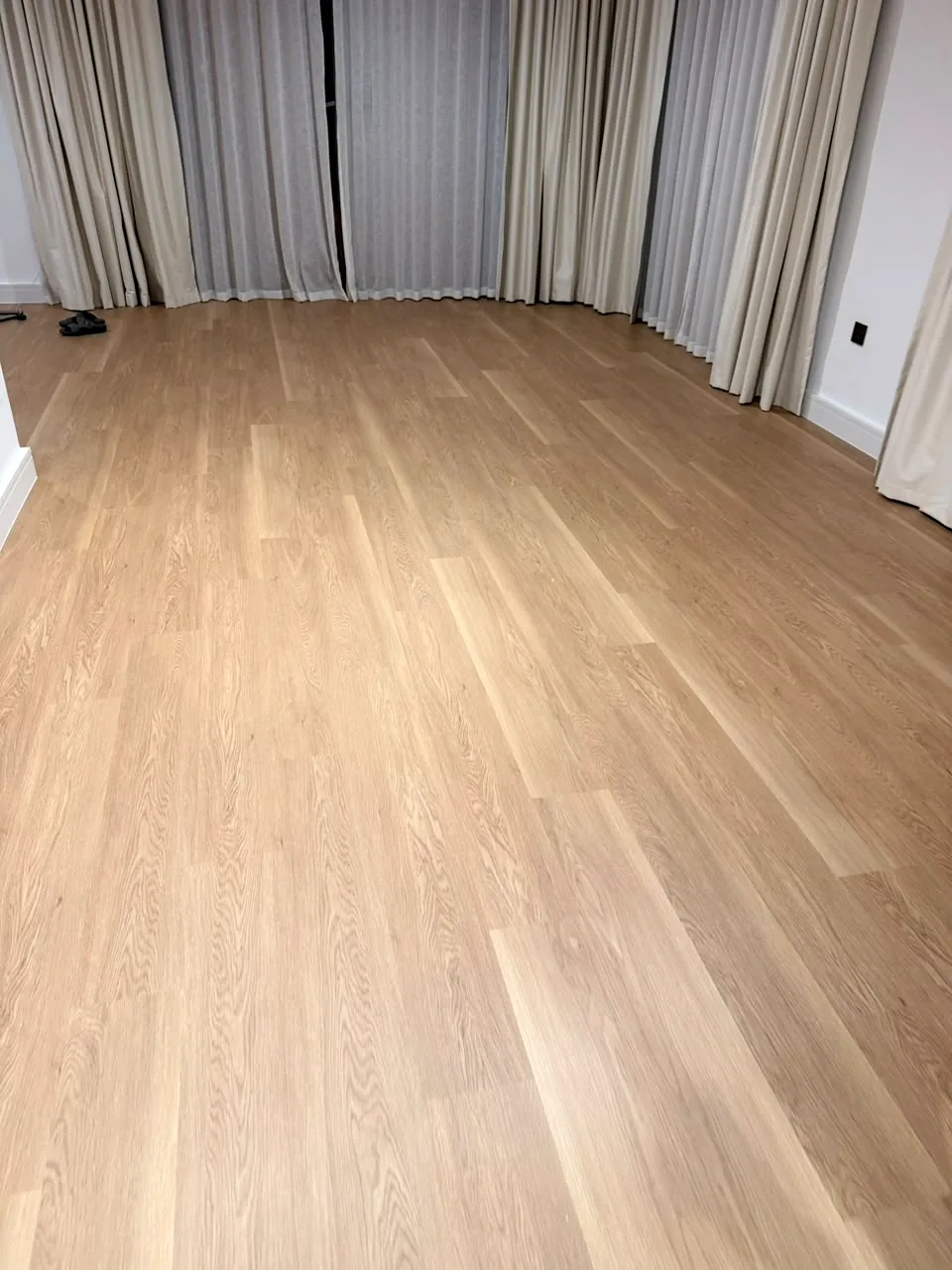 Light oak SPC flooring across a living room in an Aura Gardens villa, Tilal Al Ghaf Dubai