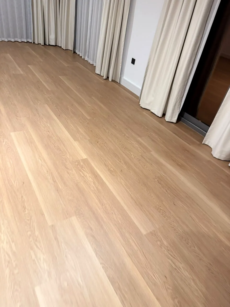 Finished SPC flooring and white skirting in a Tilal Al Ghaf Aura Gardens villa