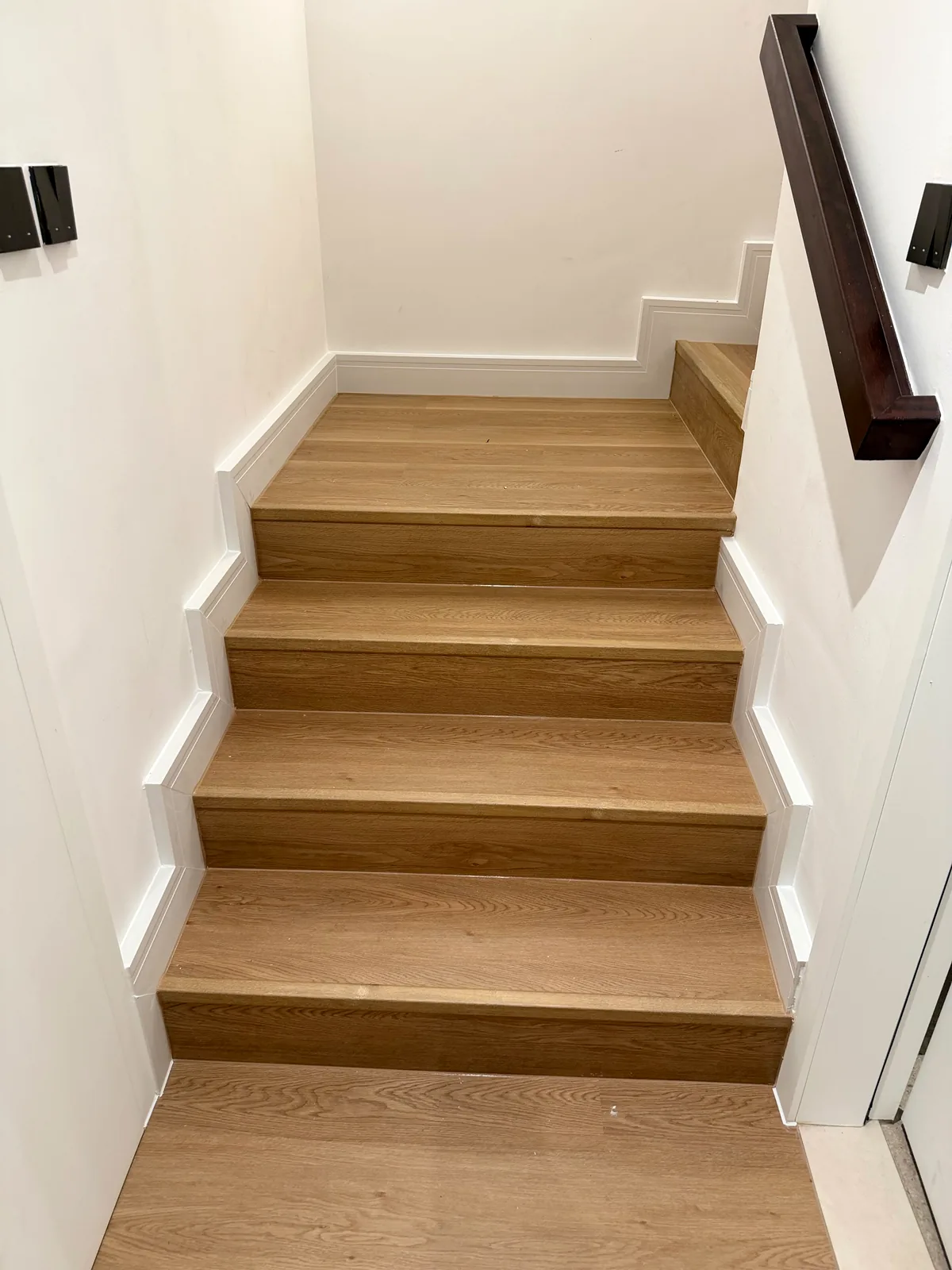 Full SPC stair cladding with white stepped skirting in Aura Gardens Tilal Al Ghaf