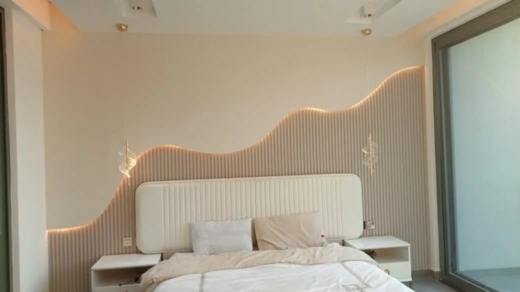 Wavy backlit slat headboard wall